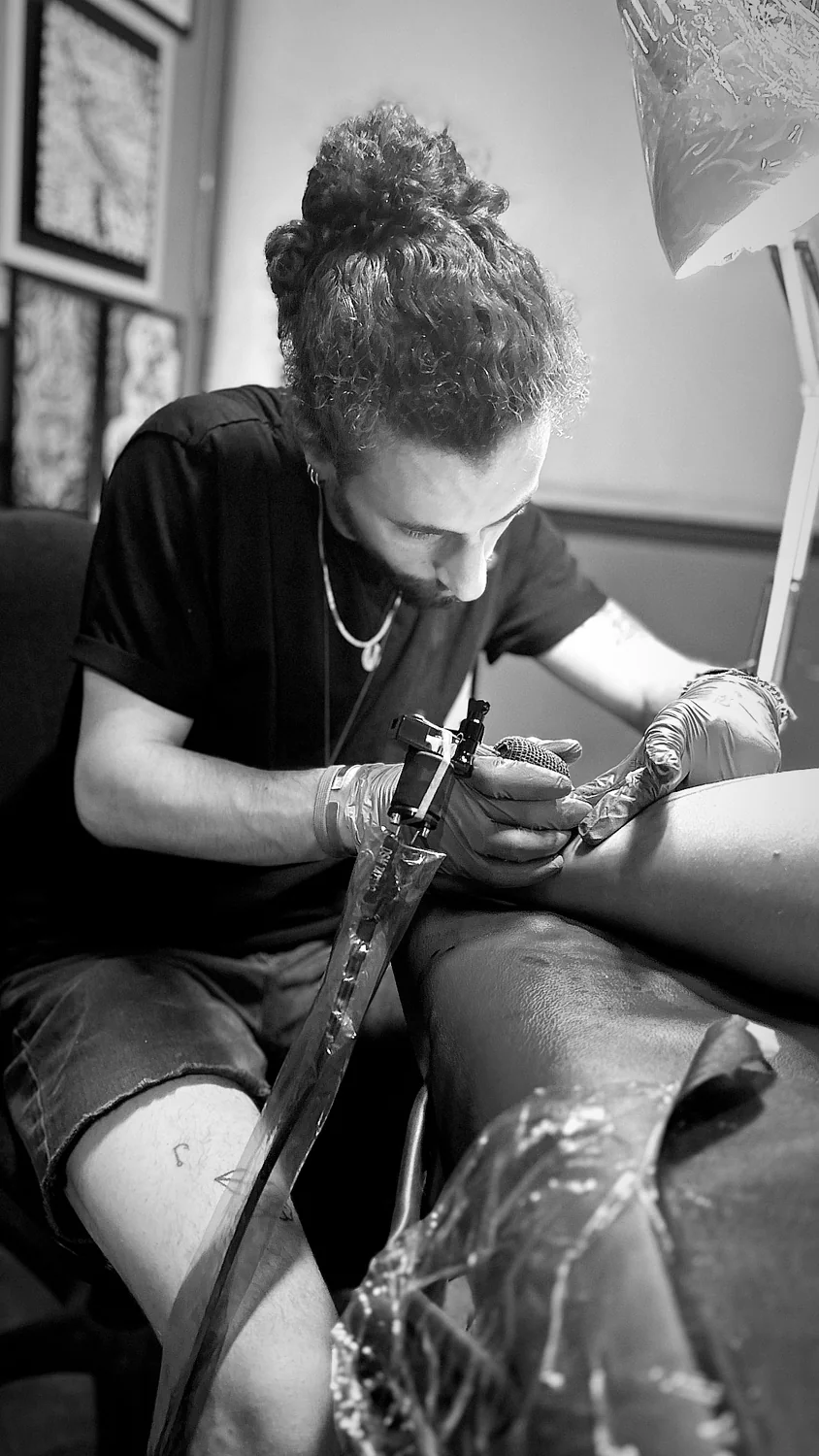Royi Caspi working on a tattoo
